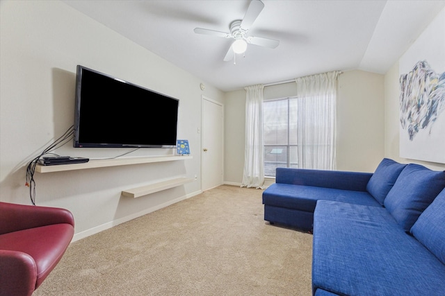 living area featuring carpet floors, lofted ceiling, baseboards, and a ceiling fan