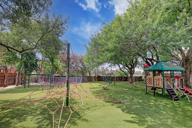 exterior space featuring playground community, a yard, and a fenced backyard