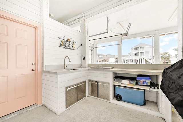 interior space featuring a sink and wood walls