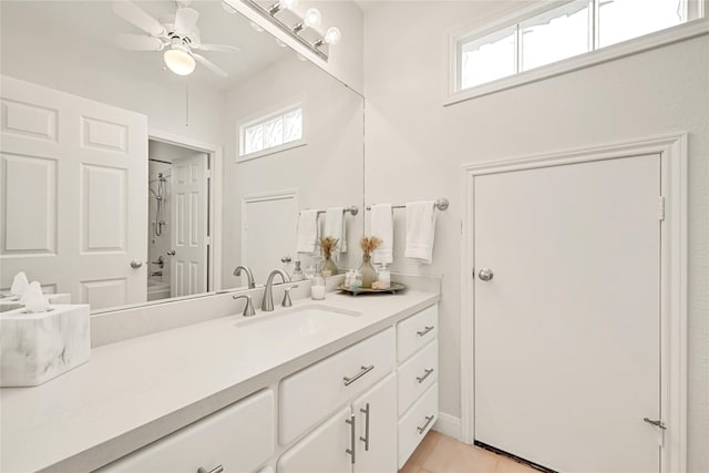 bathroom featuring a ceiling fan, plenty of natural light, vanity, and tile patterned floors