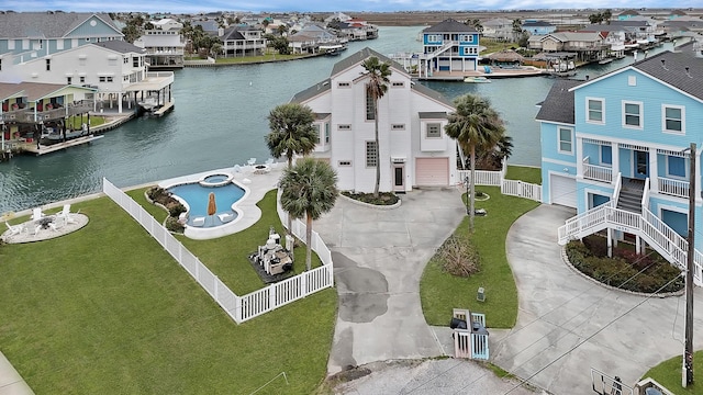 drone / aerial view featuring a residential view and a water view