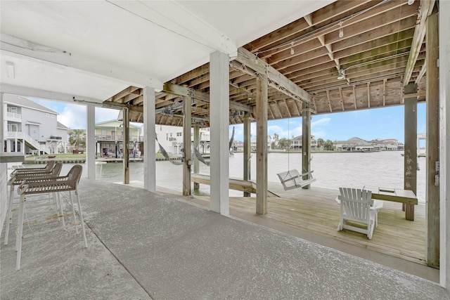 view of patio / terrace with a boat dock, a water view, and boat lift