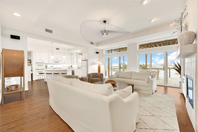 living area featuring visible vents, wood finished floors, and recessed lighting