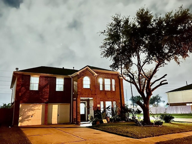 view of front of house featuring concrete driveway, brick siding, and an attached garage