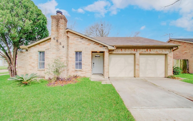 view of front of house with brick siding, a chimney, a garage, driveway, and a front lawn