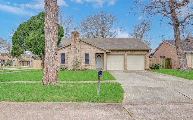 single story home featuring a chimney, an attached garage, a front yard, fence, and driveway