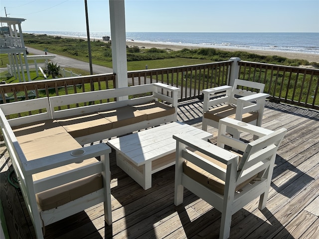 deck with a water view and a view of the beach