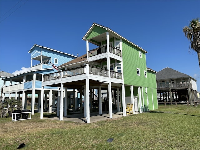 back of house featuring a carport, a yard, and a patio