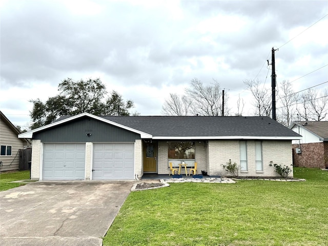 view of front of house featuring a garage, driveway, a shingled roof, a front yard, and brick siding