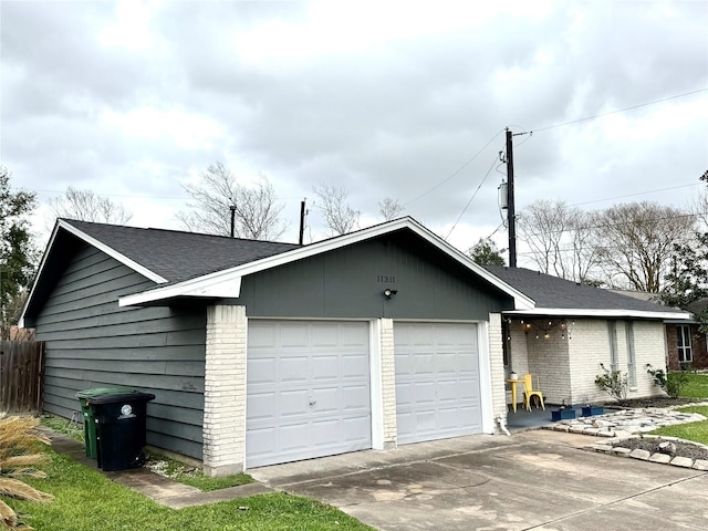 view of front of house with a garage, driveway, brick siding, and a shingled roof