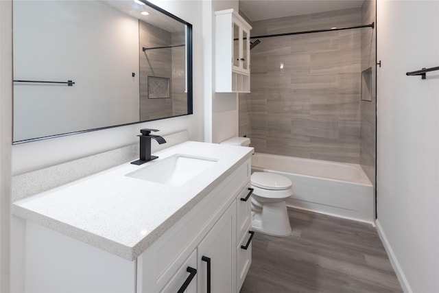 full bath with shower / bathing tub combination, toilet, vanity, wood finished floors, and baseboards