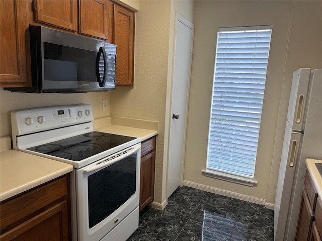 2120 El Paseo St Unit 3301, Houston, TX 77054 - kitchen featuring white appliances, brown cabinets, and light countertops
