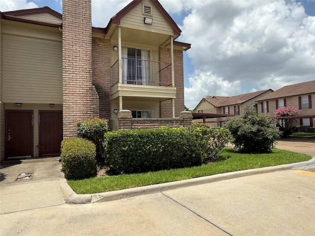 2120 El Paseo St Unit 3301, Houston, TX 77054 - view of front of property featuring a chimney, brick siding, and a balcony