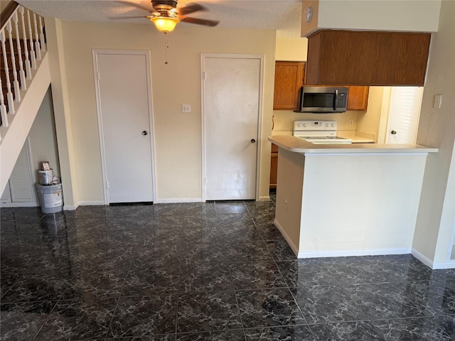2120 El Paseo St Unit 3301, Houston, TX 77054 - kitchen with stainless steel microwave, electric stove, ceiling fan, brown cabinets, and dark marble finish flooring