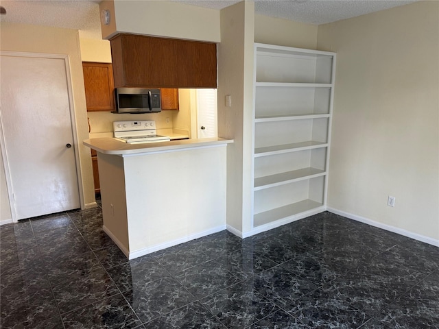 2120 El Paseo St Unit 3301, Houston, TX 77054 - kitchen with stainless steel microwave, white electric range, brown cabinetry, light countertops, and a textured ceiling