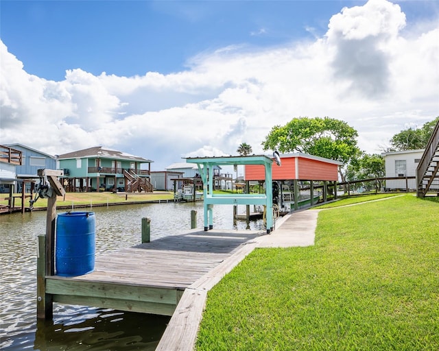 dock area featuring a water view, boat lift, and a lawn