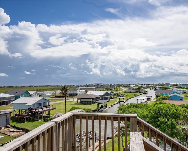 balcony with a residential view and a water view