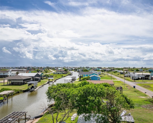 birds eye view of property with a water view and a residential view