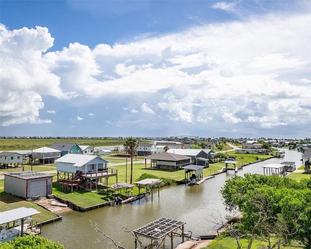 water view with a dock, boat lift, and a residential view