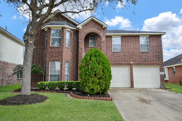 traditional-style house featuring a garage, concrete driveway, brick siding, and a front lawn