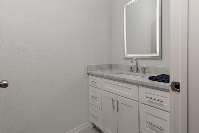 bathroom featuring vanity and baseboards