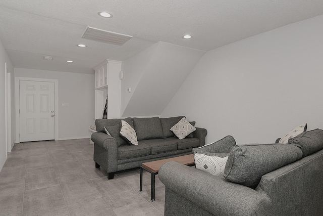 living room with recessed lighting, visible vents, baseboards, and a textured ceiling