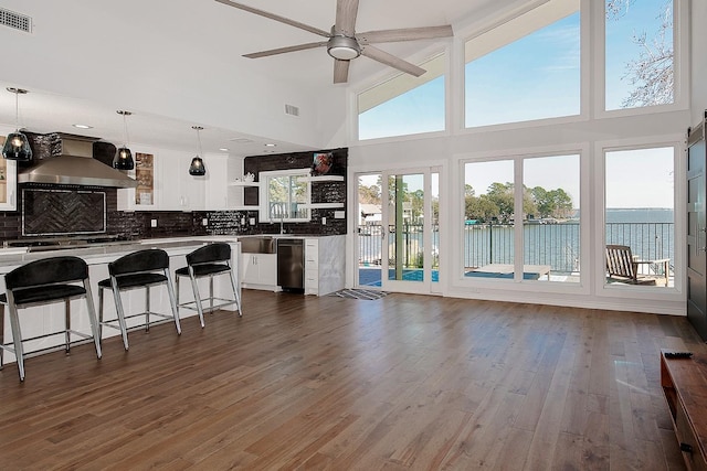 kitchen featuring open shelves, visible vents, backsplash, and wall chimney range hood