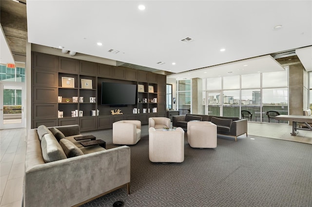 living room with visible vents, a wall of windows, and recessed lighting