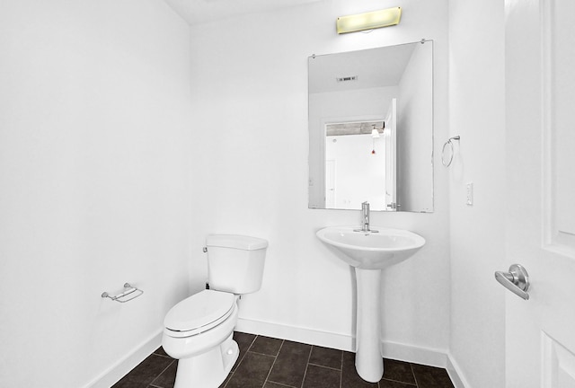 half bathroom featuring visible vents, tile patterned flooring, toilet, and baseboards