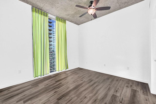 unfurnished room with ceiling fan, baseboards, and wood finished floors