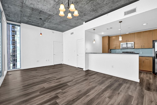 kitchen featuring dark wood-style floors, visible vents, appliances with stainless steel finishes, and brown cabinetry