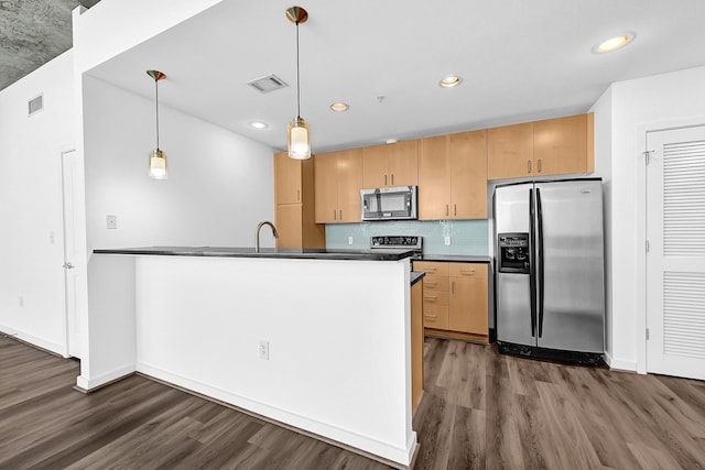 kitchen with dark countertops, visible vents, appliances with stainless steel finishes, and dark wood-style flooring