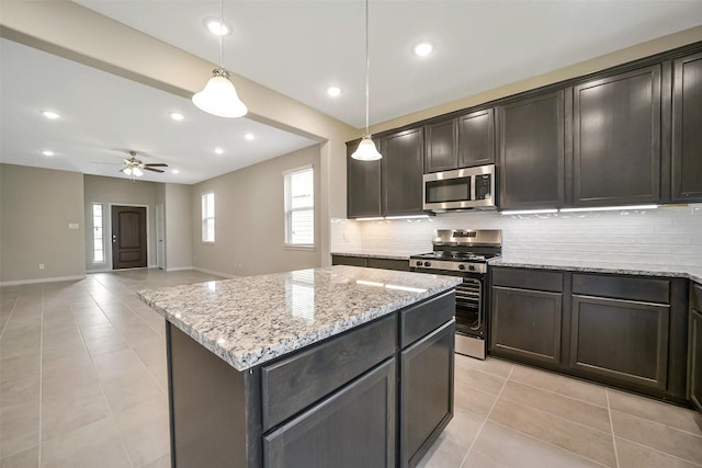 4215 Sternside Ln, Houston, TX 77053 - kitchen featuring stainless steel appliances, tasteful backsplash, light tile patterned floors, a ceiling fan, and recessed lighting