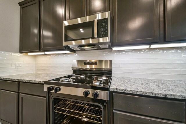 4215 Sternside Ln, Houston, TX 77053 - kitchen featuring appliances with stainless steel finishes, dark brown cabinets, and tasteful backsplash