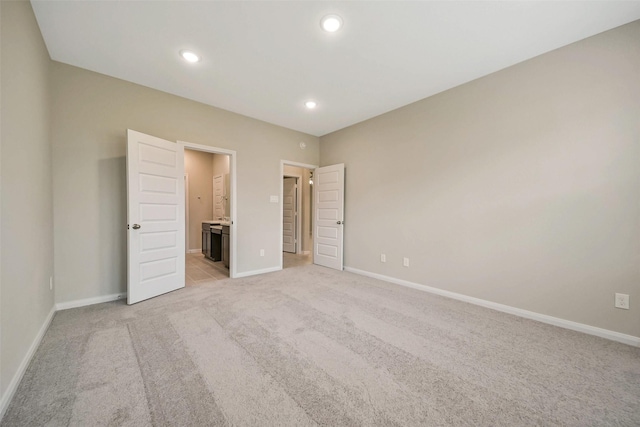 4215 Sternside Ln, Houston, TX 77053 - unfurnished bedroom with light colored carpet, baseboards, recessed lighting, and ensuite bath