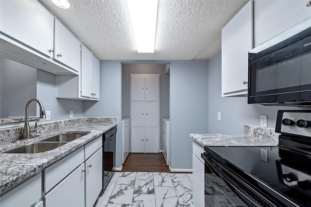 kitchen with black appliances, marble finish floor, white cabinets, and a sink