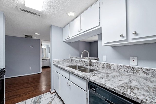 kitchen featuring black dishwasher, visible vents, marble finish floor, white cabinetry, and a sink