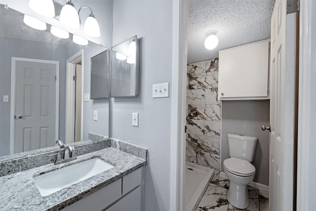 full bathroom featuring a textured ceiling, toilet, vanity, marble finish floor, and a stall shower