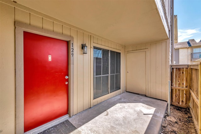 property entrance featuring a patio and fence