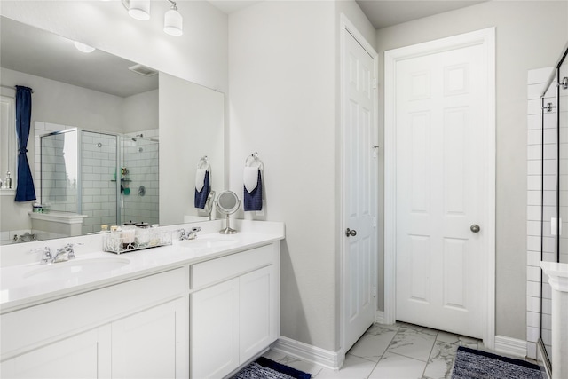 full bathroom with marble finish floor, a stall shower, a sink, and baseboards