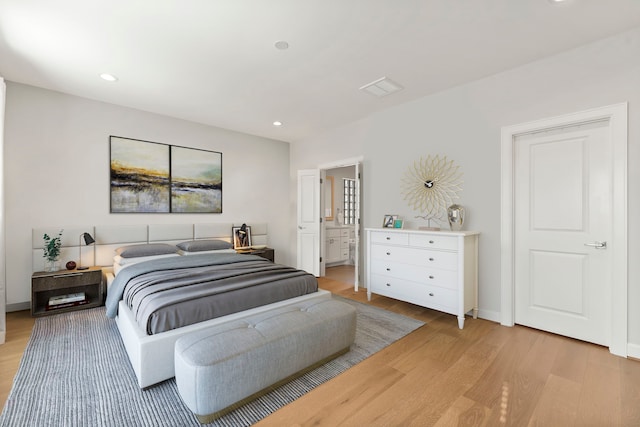 bedroom featuring light wood-style floors, baseboards, visible vents, and recessed lighting