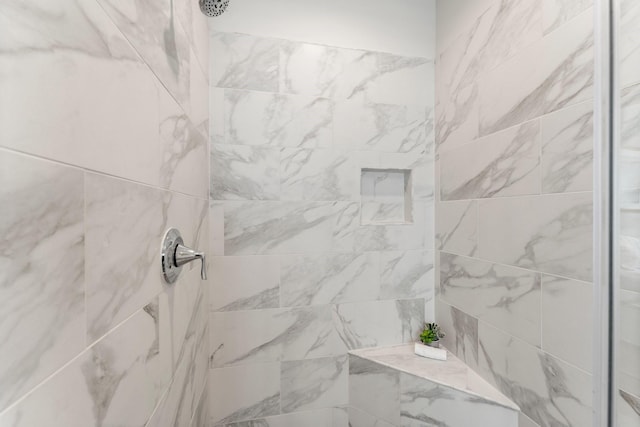 bathroom with a tile shower