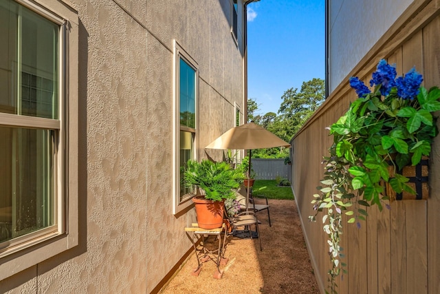 view of property exterior with fence and stucco siding