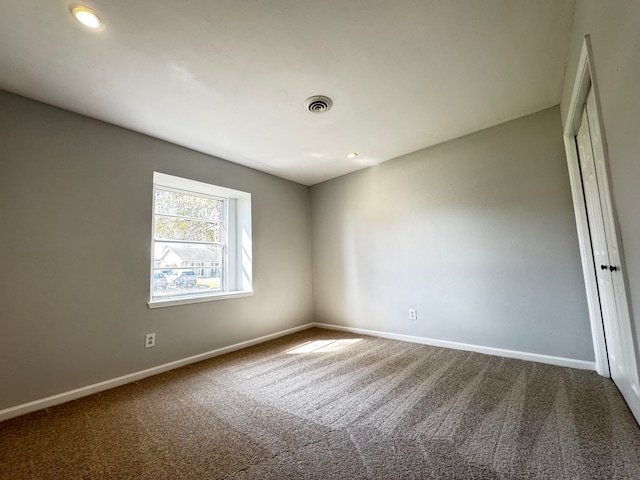 empty room featuring recessed lighting, carpet flooring, visible vents, and baseboards