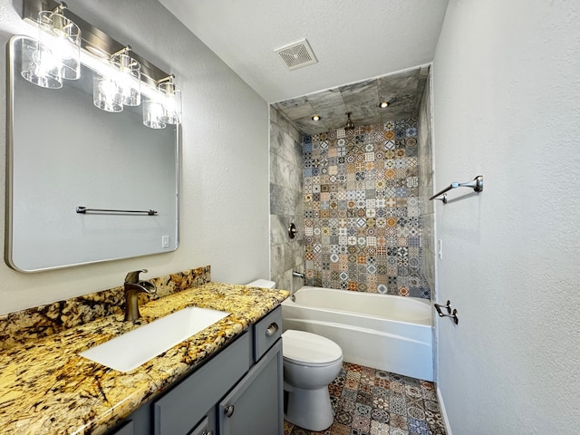 full bath featuring visible vents, a textured wall, toilet,  shower combination, and vanity