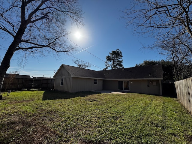 back of property featuring a yard, a patio area, and a fenced backyard