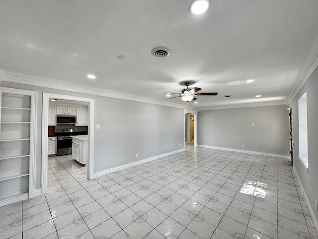 spare room with built in features, crown molding, visible vents, a ceiling fan, and baseboards