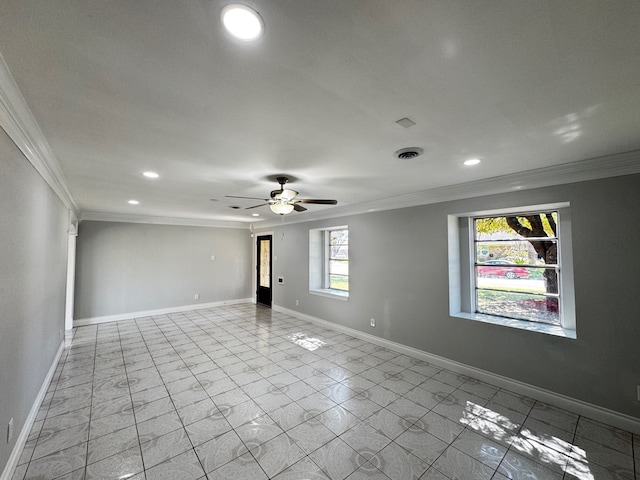 spare room with ornamental molding, visible vents, and baseboards