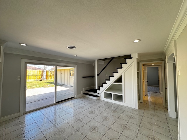 spare room with stairway, baseboards, visible vents, and ornamental molding