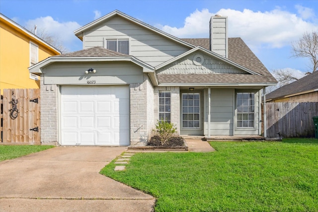 view of front of house featuring an attached garage, a shingled roof, a front yard, and fence